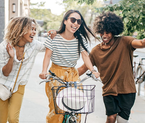 Three friends walking and smiling together