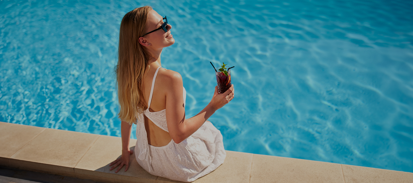 Woman sitting by pool